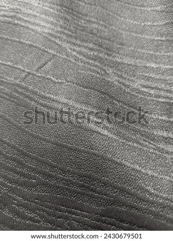 a surface of a dark grey fabric