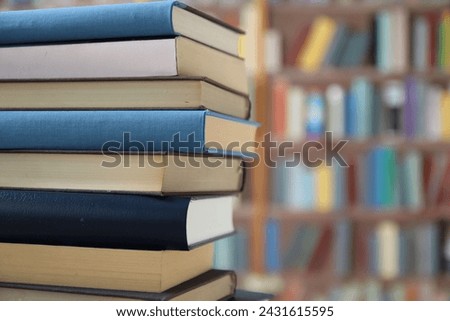 stack of books on wooden table in library, education