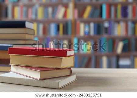 stack of books on wooden table in classroom, back to school. space for text