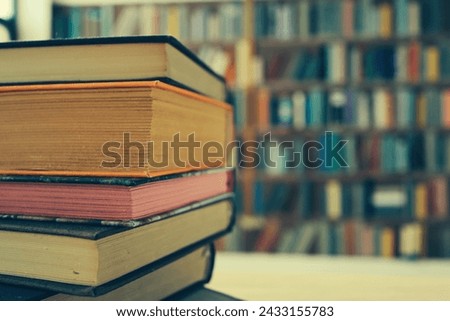 many colorful books on the shelf in the library
