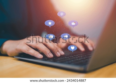 man hand using notebook computer laptop with Social media icons.Social, media, Marketing concept.
