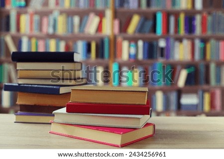 stack of books and glasses on wooden table in library