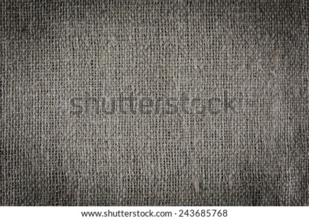 A background texture of burlap cloth dark vignette