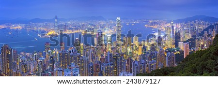 Hong Kong Panorama. Panoramic image of Hong Kong with many skyscrapers during twilight blue hour.