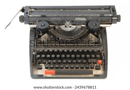 Antique black typewriter against a white background