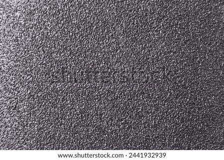 Texture of coarse sandpaper as background, top view