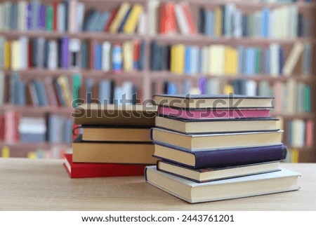 stack of books on wooden table against blurred background. space for text, education, school