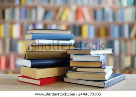stack of books on wooden table against blurred background. space for text, education, school
