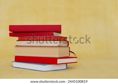 stack of books in hands of student, stack of books on color background, education, school,
