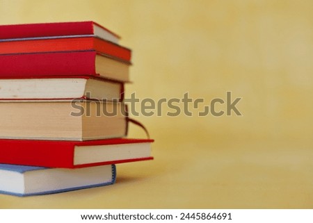 stack of books in hands of student, stack of books on color background, education, school,