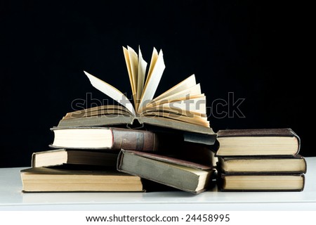 Books on the table. Isolated over black background