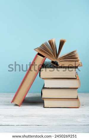 Open book, hardback colorful books on wooden table. Back to school. Copy space for text. Education business concept
