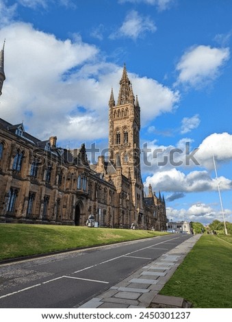 The tower of the University of Glasgow, Scotland, United Kingdom. The most recognizable place in Glasgow. View of the tower and part of the university building on a summer day. 