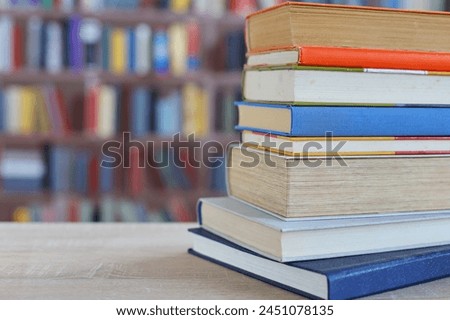 many different colored books, stack of books on wooden table in library, education, library
