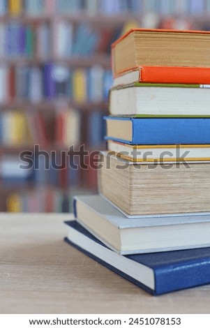 many different colored books, stack of books on wooden table in library, education, library