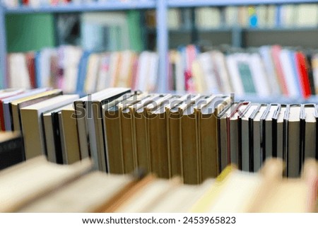 stack of books on shelves in library