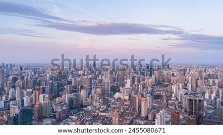 
Aerial view of modern city skyline and buildings at sunrise in Shanghai.