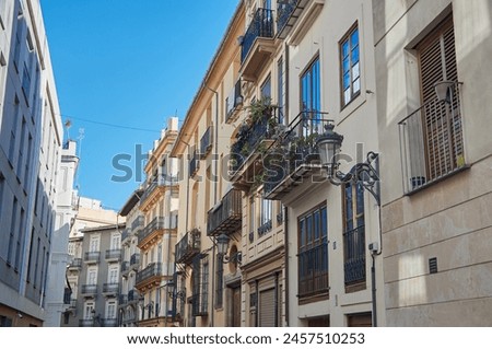 Traditional Spanish street with European balconies and blue sky Spain