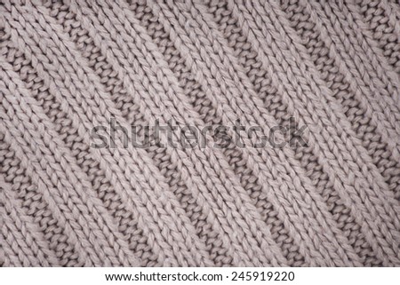 Detail of crocheted gray texture from a sweater made of wool 