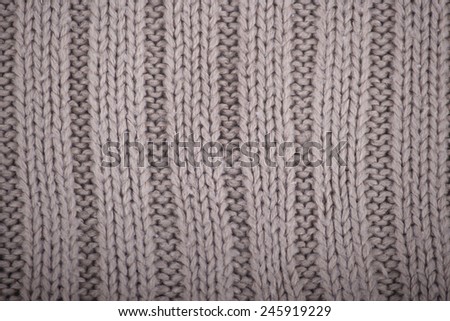 Detail of crocheted gray texture from a sweater made of wool 
