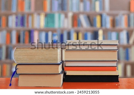 stack of books against the background of library, stack of books in front of library, books on wooden table