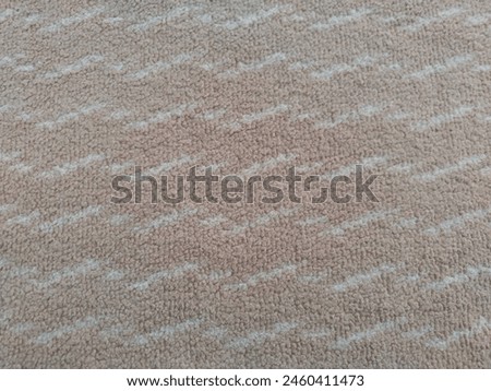 A mocha colored carpet with a wave pattern on the floor

￼


