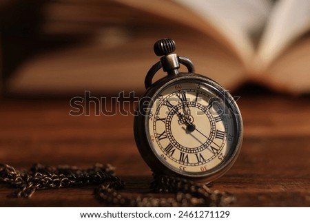 Pocket clock with chain on table, closeup