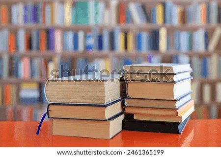 stack of books against the background of library, stack of books in front of library, books on wooden table