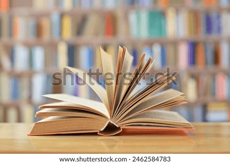 book with open pages, close up, books on the shelf in school, open book on wooden table. back to school concept