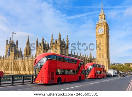 Houses of Parliament with Big Ben and double-decker buses on Westminster bridge, London, UK