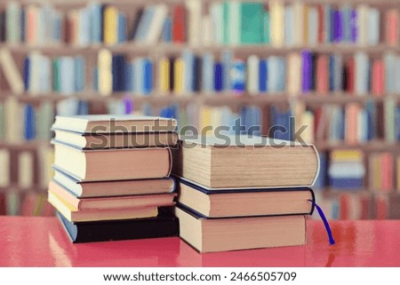 stack of books on wooden background in library