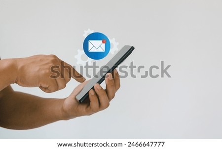 Man hand holding smartphone with email icon. Contact us by newsletter email and protect your personal information from spam mail. Customer service call center contact us. Email marketing concept.