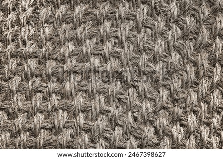 The texture of the vintage gray jute mat, background.