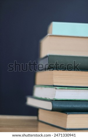 Green books on the table on black background