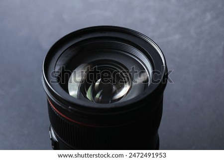 Professional lens on a black background. Photographer's equipment