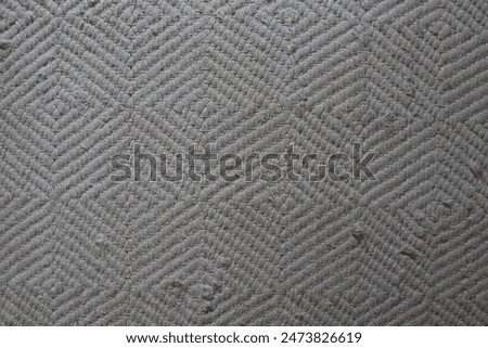 Geometric Textured Pattern on Grey Fabric Background. Design for clothing decor or textile