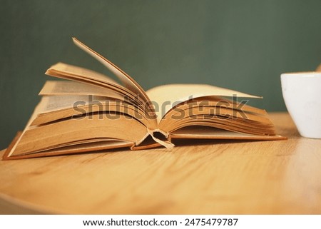 open book and a pencil on wooden table 