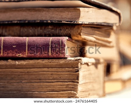 Close-up of a Stack of Antique Books with Weathered Pages