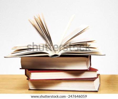 A pile of books on table and white background 