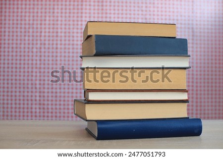 stack of books on wooden table in library, croatian background