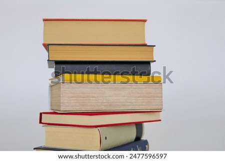 book, stack of books on white background, many different books on grey background, education