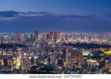 The sun sets over the sprawling cityscape of Tokyo.