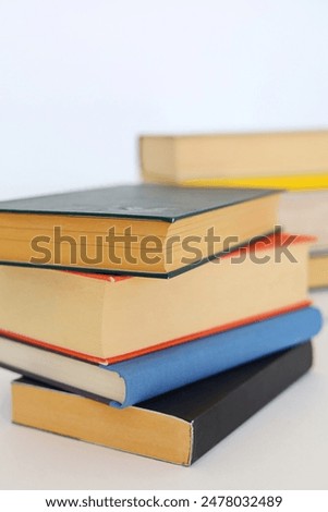 Beautiful books by famous writers on a white background, learning, knowledge, reading, schooling, studying, English language, Spanish language, Chinese language