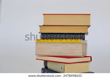 book, stack of books on white background, many different books on grey background, education