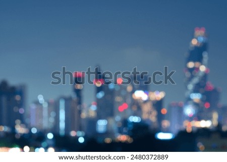 Abstract blurred background cityscape of Krung Thep Maha Nakhon (Bangkok) on night scene with multicolour bokeh from neon light on building