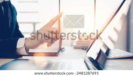 e-mail concept, businessman working in office with email icon