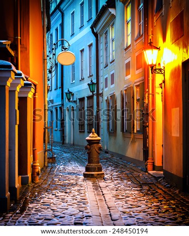Narrow medieval street in old Riga city by winter at the early morning