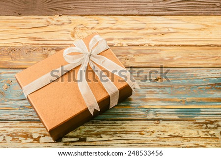 Gift box on wooden background - vintage effect