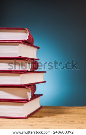 books on wooden table  with blue background