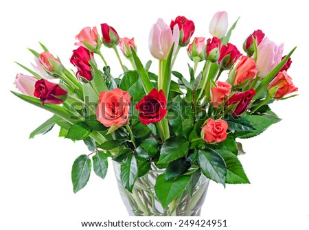 Red and orange roses flowers with pink tulips in a transparent vase, isolated, white background.